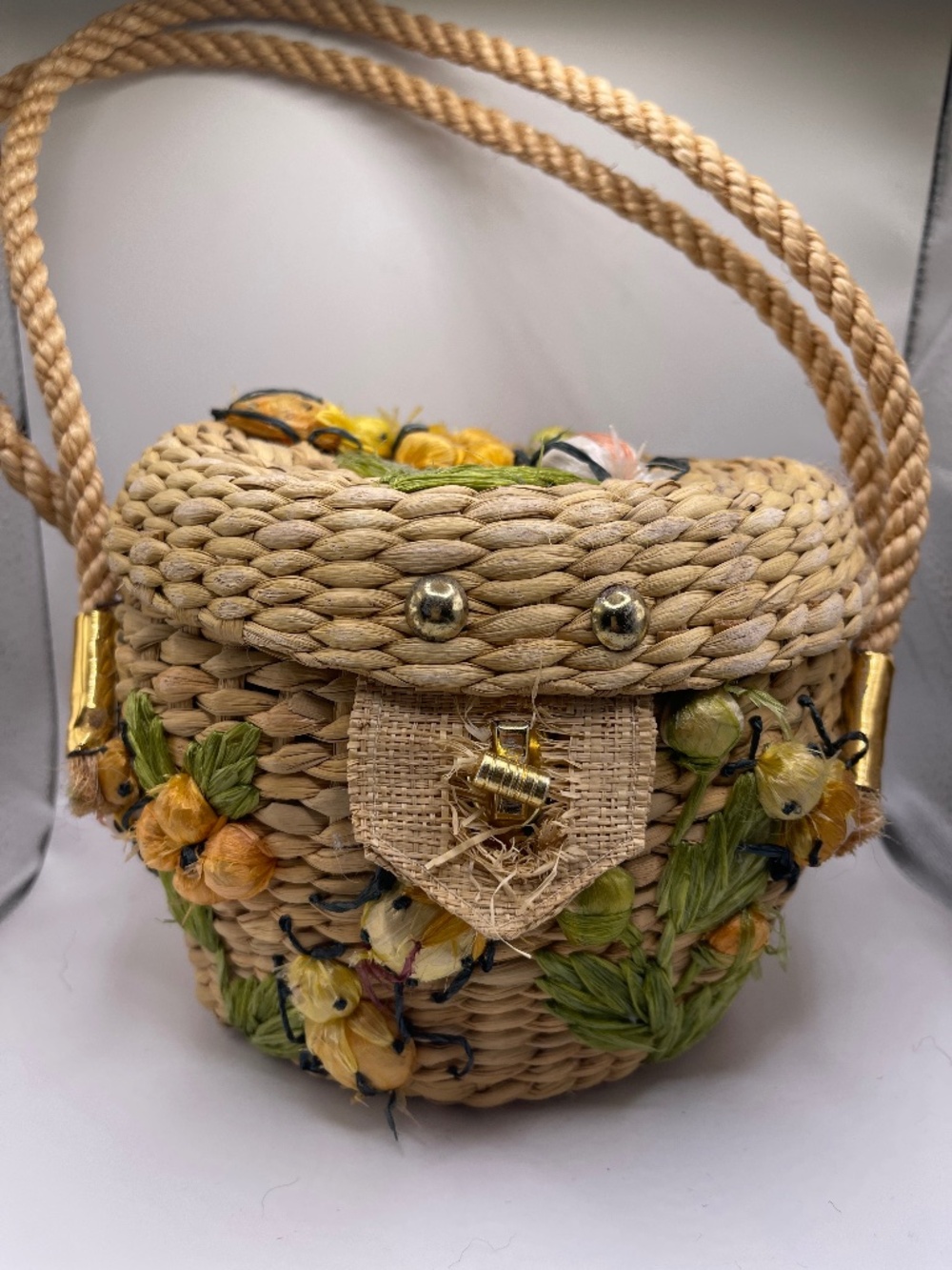 Unique woven basket bag with bug and flower accents